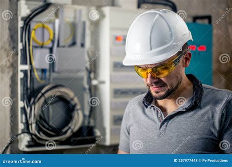 Male Electrician With Safety Glasses And A Helmet Near The Switchboard Stock Image Image Of