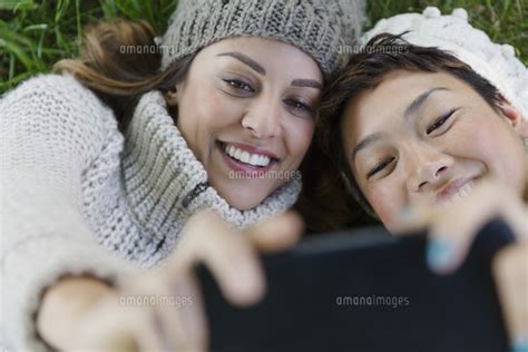 Overhead Smiling Female Friends Taking Selfie With Camera Phone