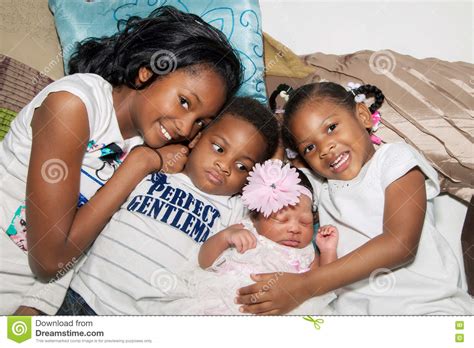African American Siblings Hugging On Floor Stock Photo Image Of