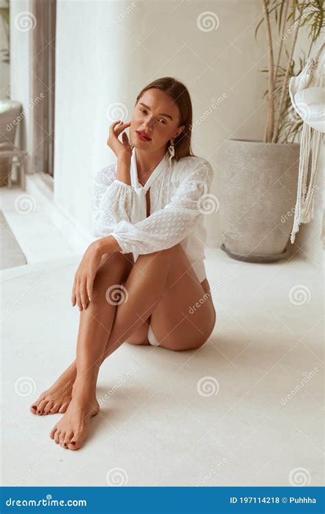 Beautiful Girl Sitting On Floor Model In Long Sleeve Blouse Relaxing On Porch Portrait Stock