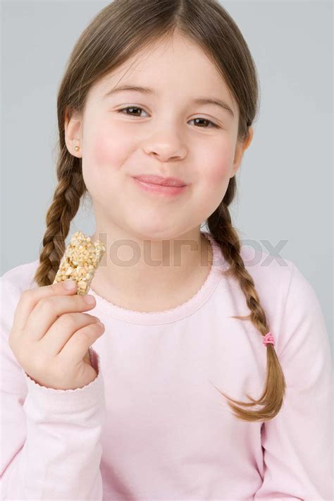 Girl Eating Cereal Bar Stock Image Colourbox