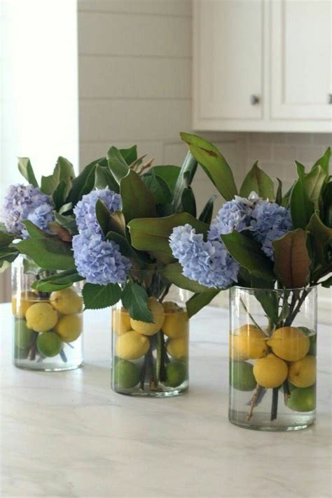 lemons blue flowers three bouquets round vases floral centerpieces marble countertop flower