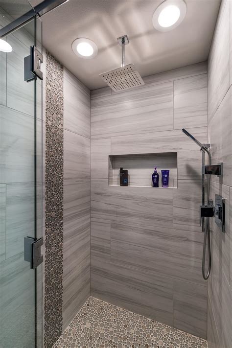 Shelves like this above bath tub. Walk-In Shower With Pebble Tiles | HGTV