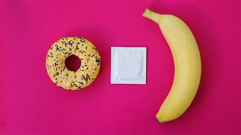 Premium Photo Banana Donut And Condom Sex Idea Bright Picture On A Pink Background The