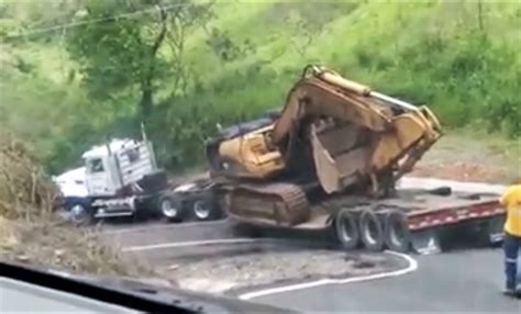 Hairpin Turn Causes Excavator To Fall Off Trailer