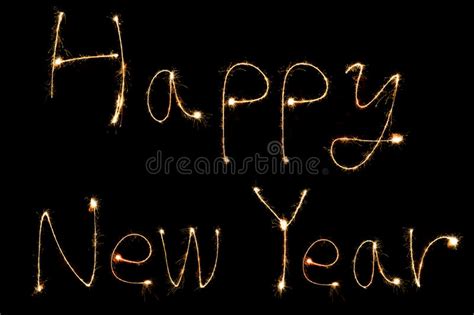 Burning Sparkler Stick And Writing Happy New Year Words Stock Photo