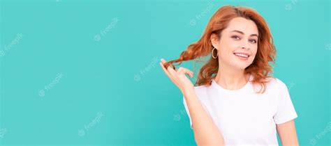 Premium Photo Glad Redhead Girl With Curly Hair On Blue Background Woman Isolated Face