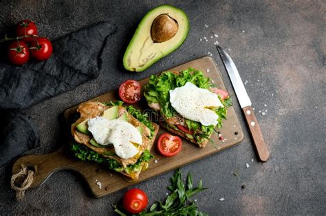 Delicious Sandwich With Avocado And Poached Egg Stock Photo Image Of