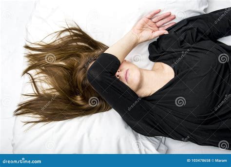 Depressed Young Woman Is Lying In Her Bed Covering Her Eyes Stock