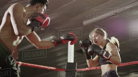 Close Up Of Female Boxer Protecting Her Face Standing In Boxing Ring