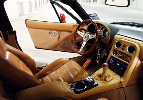 The Interior Of A Car With Tan Leather And Wood Trims Including