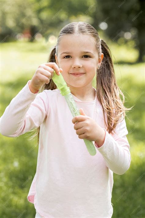 Free Photo Girl Holding A Green Toy