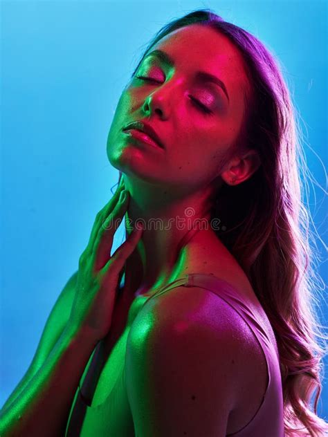 woman skincare glowing or neon lighting on isolated blue background and hands on neck body or