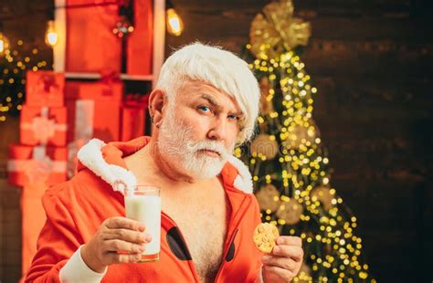 Christmas Santa Claus Enjoys Cookies And Milk Left Out For Him On Christmas Eve Stock Image