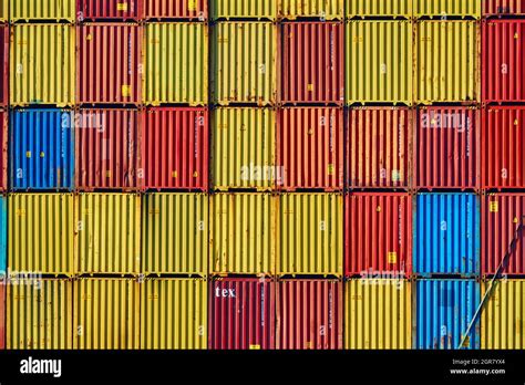 Shipping Containers Stacked On Top Of Each Other In Bright Colours