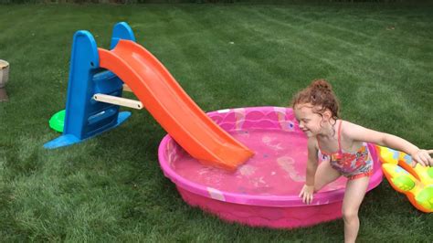 Funny Little Girl Explaining How To Go Down A Water Slide Into A Kiddie