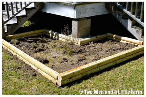 A Wooden Garden Bed In The Middle Of Grass And Dirt With Stairs Leading