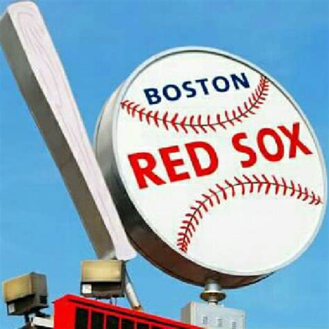 A Boston Red Sox Baseball Sign On Top Of A Building