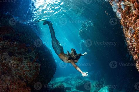 Mermaid Swimming Underwater In The Deep Blue Sea 20347217 Stock Photo