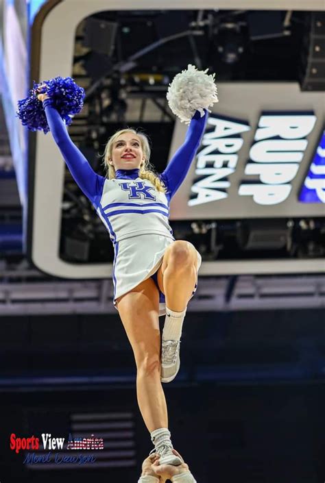A Cheerleader Is Performing In The Air