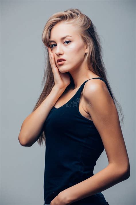 Beautiful Young Woman In Black Shirt On Grey Background Stock Image