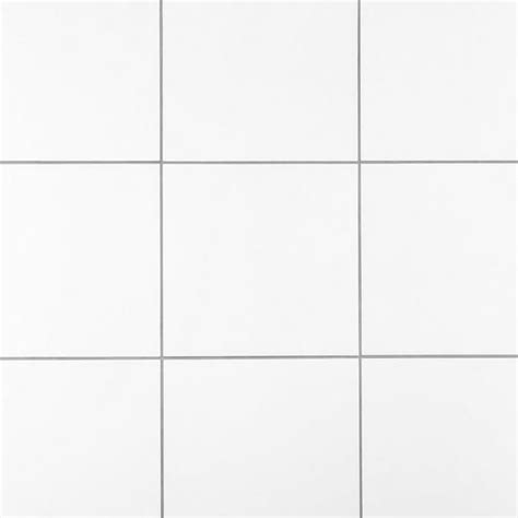 A White Tiled Wall With Several Different Sized Tiles On The Bottom And