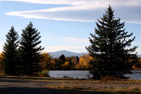 Autumn Landscape with Lake, Fall Trees & Mountains in the Background