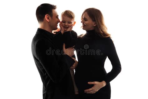 Pregnant Woman Her Husband And Little Son Are Talking And Smiling While Spending Time Together