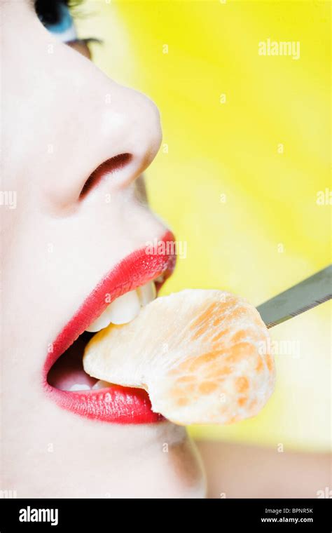 Beautiful Caucasian Woman Portrait Eating A Tangerine Slice Studio On