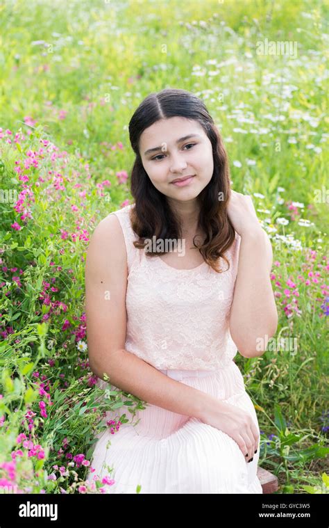 Pretty Girl Sits On Richly Meadow Stock Photo Alamy