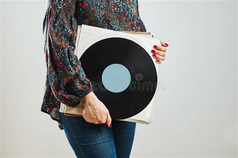 woman holding vinyl records music passion listening to music from analog record playing music