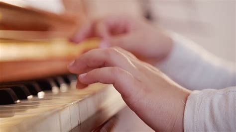 Music Lesson Girl Playing Piano Close Up On Piano Keys Child Hands