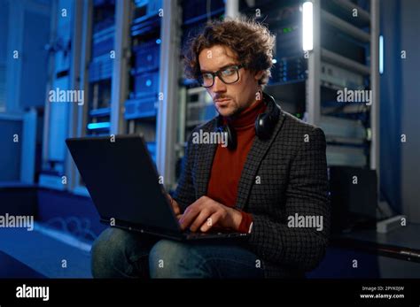 Network Engineer Using Digital Tablet In Server Room During Maintenance