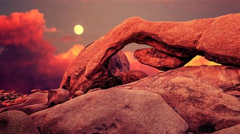 Sunset And Rising Moon Over Arch In Joshua Tree National Park