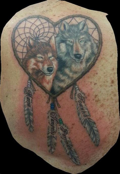 Two Wolfs In A Heart Shaped Dream Catcher Tattoo