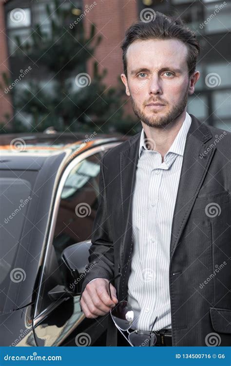 Attractive Successful Young Businessman In A Business Suit Near Stock