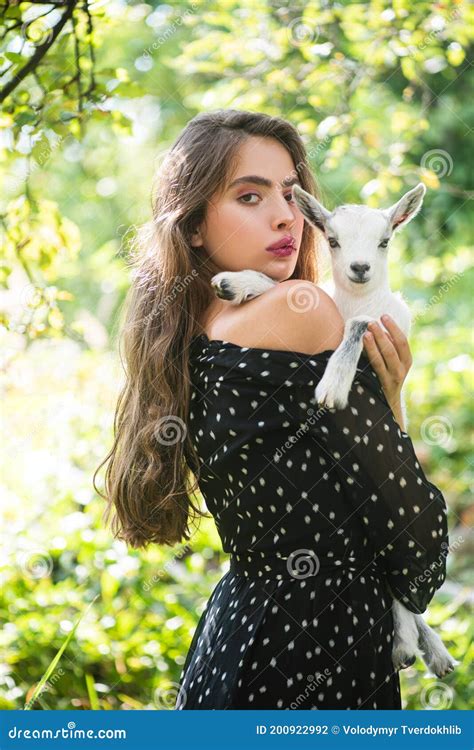Natural Young Woman Virgin Girl In Village Hold Yeanling Stock Photo