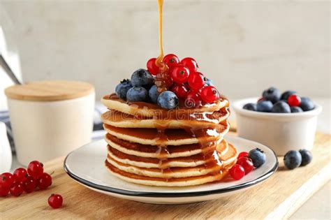 Pouring Syrup Onto Pancakes With Fresh Berries Stock Image Image Of