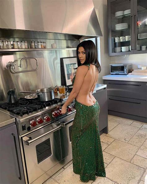 Kourtney Kardashian Shows Off Booty Cleavage In Gown While Cooking