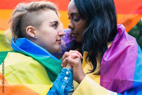 Loving Lesbian Couple Holding Hands And Gazing Into Each Others Eyes At A Lgbtq Rights Rally