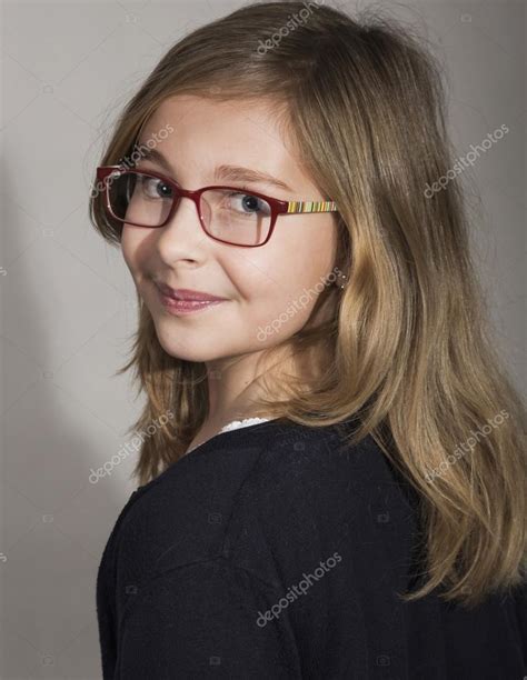 Studio Portrait Of Beautiful Young Girl With Blond Hair Girl Wearing