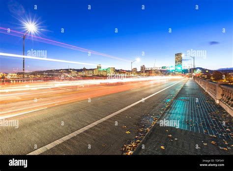 Traffic On Road With Cityscape And Skyline Of Portland At Twilig Stock