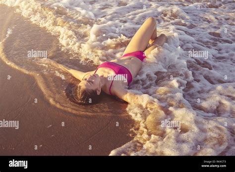 Bikini Girl Relaxed Lying On The Beach Sand Shore Water Of