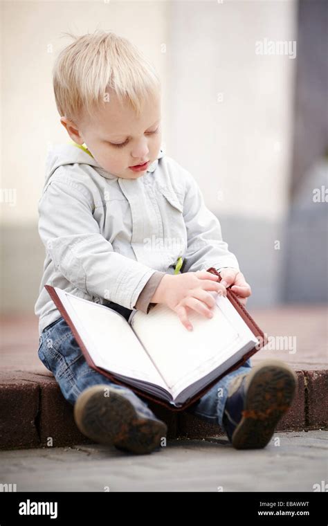 Little Boy Reads A Book Stock Photo Alamy