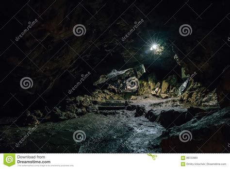 Exit From Big Dark Scary Underground Cave In Form Of Tunnel Stock Photo