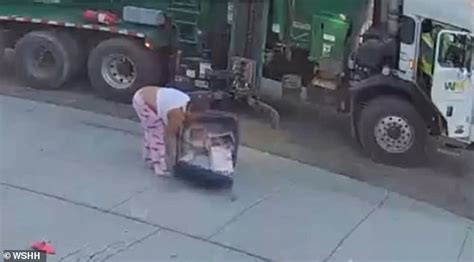 woman falls head first into a trash can twice while rushing to catch the garbage truck daily