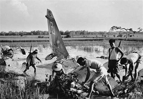 North Vietnamese Militia Members Sort Through The Wreckage Of A Downed