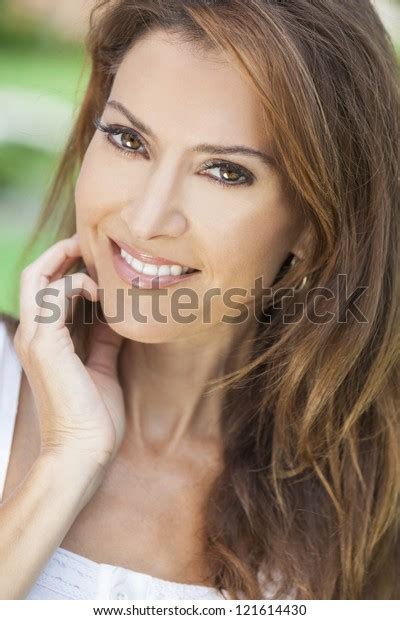 Outdoor Portrait Of A Beautiful Middle Aged Brunette Woman In Her Forties
