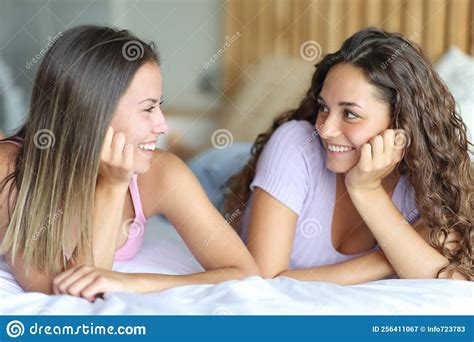 happy women looking each other on a bed stock image image of smiling girls 256411067