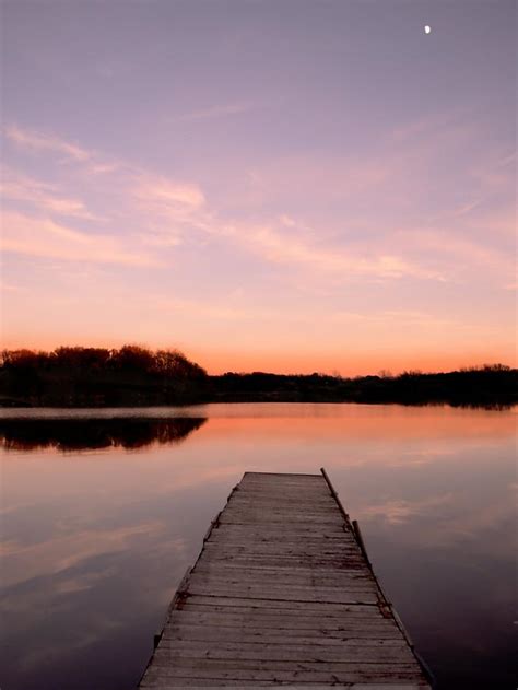 Sunset On Dock With Tiny Moon Photograph By Photo By Stacie Barton